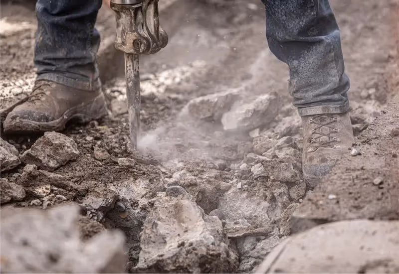 Close up of a jackhammer breaking up concrete